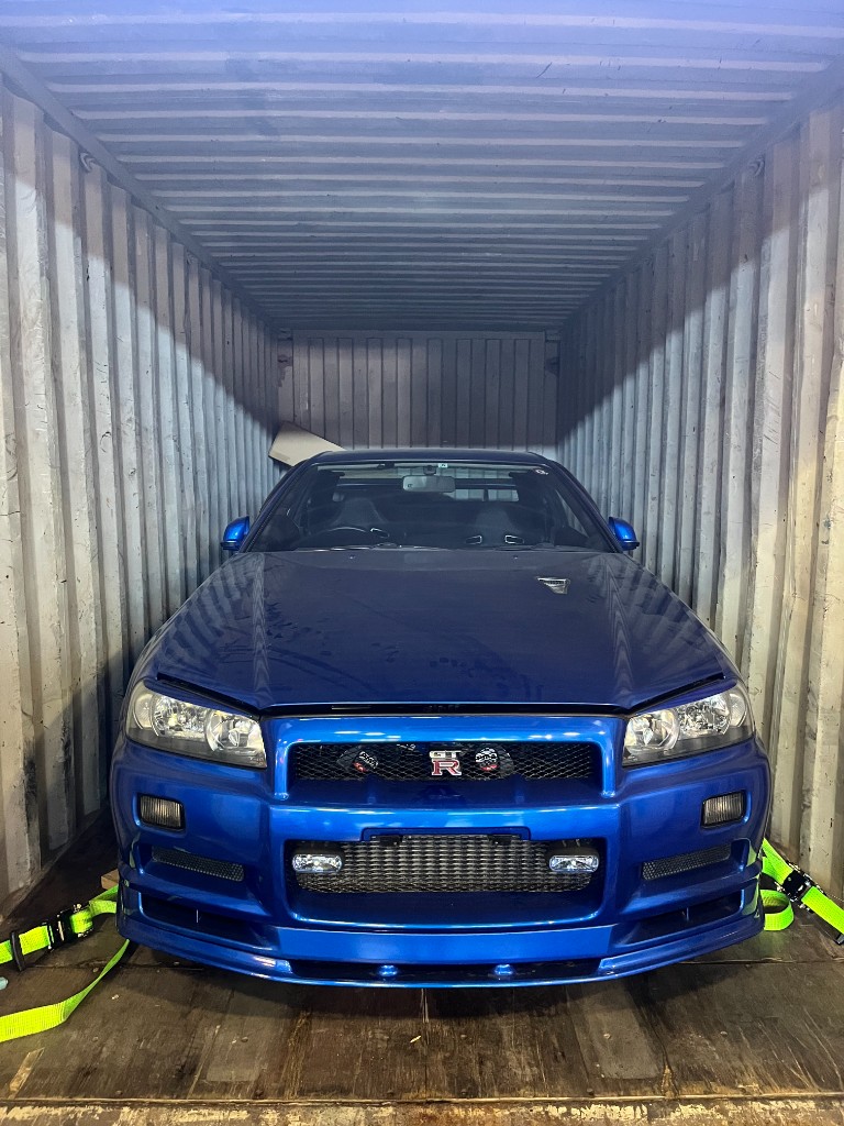 Vehicle secured in a shipping container